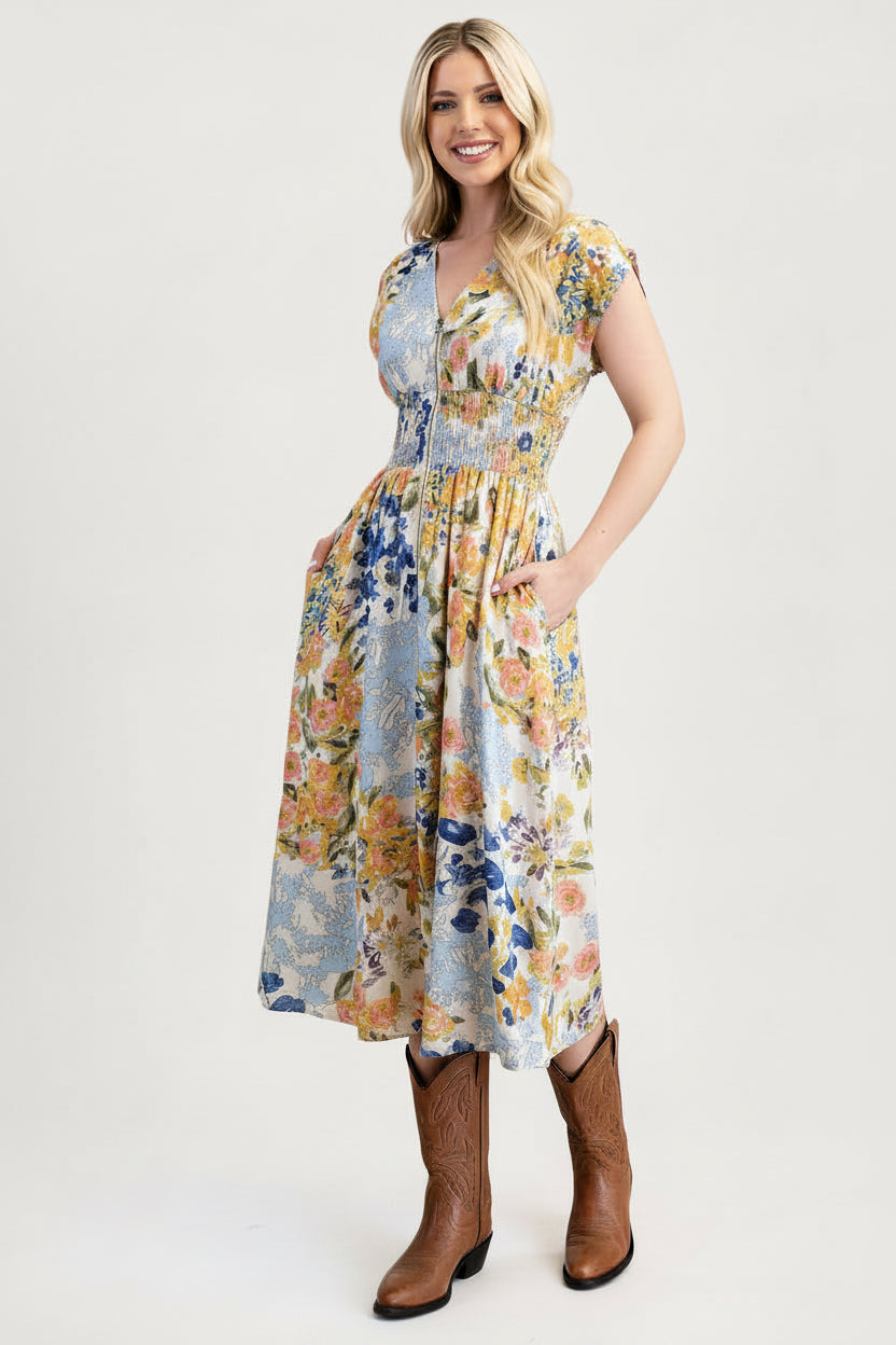 Woman wearing a floral dress with brown boots on a white background